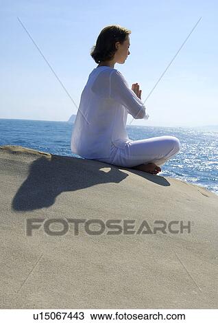 Side profile of a young woman practicing yoga View Large Photo Image Stock Image - Side profile of a young woman practicing yoga. Fotosearch
