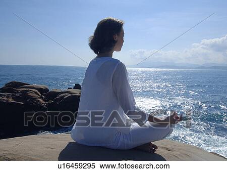 Side profile of a young woman practicing yoga View Large Photo Image Stock Photography - Side profile of a young woman practicing yoga. Fotosearch