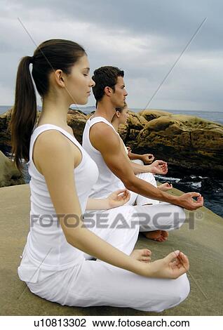 Side profile of two young women and two young men practicing yoga View Large Photo Image Stock Image - Side profile of two young women and two young men practicing yoga. Fotosearch