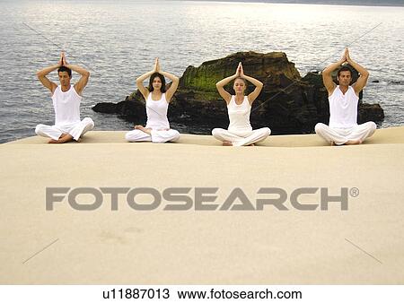 Two young men and two young women practicing yoga View Large Photo Image Stock Image - Two young men and two young women practicing yoga. Fotosearch