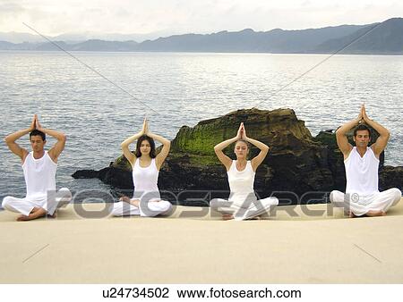 Two young men and two young women practicing yoga View Large Photo Image Stock Image - Two young men and two young women practicing yoga. Fotosearch