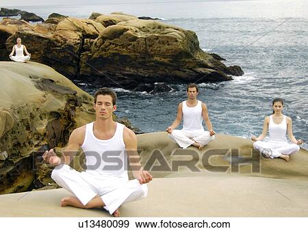 Two young men and two young women practicing yoga View Large Photo Image Stock Photo - Two young men and two young women practicing yoga. Fotosearch