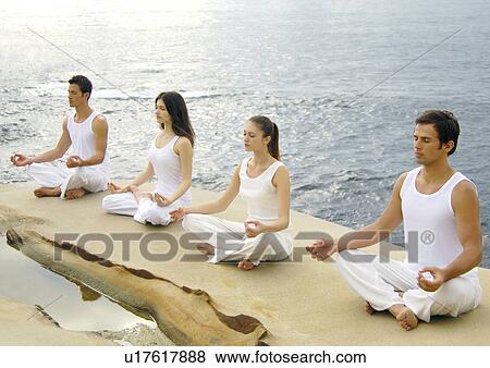 Two young men and two young women practicing yoga View Large Photo Image Stock Photo - Two young men and two young women practicing yoga. Fotosearch
