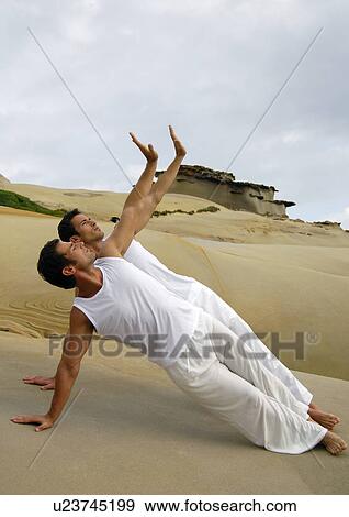 Two young men practicing yoga View Large Photo Image Stock Photo - Two young men practicing yoga. Fotosearch