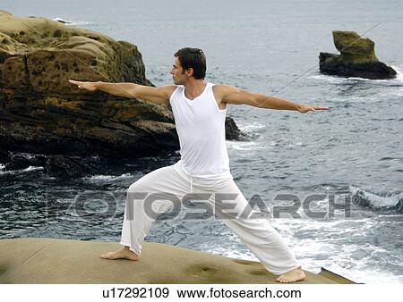 Stock Photo - Young man practicing yoga. Fotosearch