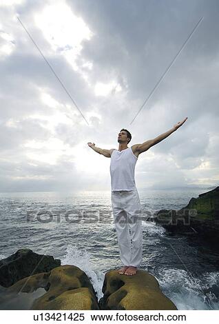 Young man practicing yoga View Large Photo Image Stock Photography - Young man practicing yoga. Fotosearch