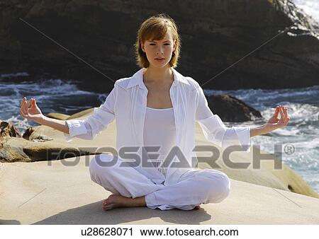 Young woman practicing yoga View Large Photo Image Stock Image - Young woman practicing yoga. Fotosearch