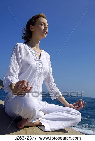 Young woman practicing yoga View Large Photo Image Stock Photo - Young woman practicing yoga. Fotosearch