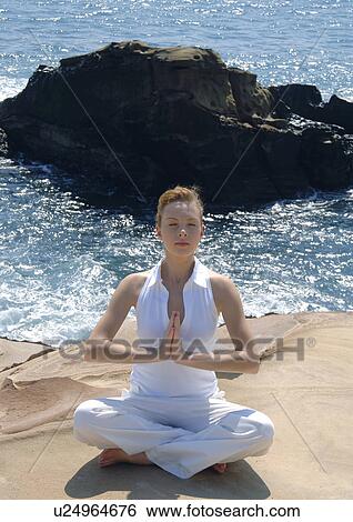 Young woman practicing yoga View Large Photo Image Stock Photograph - Young woman practicing yoga. Fotosearch