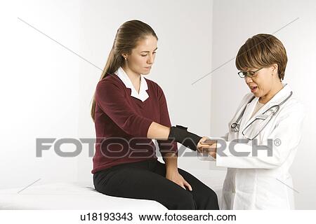 African American middle-aged female doctor examining wrist of Caucasian mid-adult female patient. View Large Photo Image Stock Image - African American middle-aged female doctor examining wrist of Caucasian mid-adult female patient.. Fotosearch