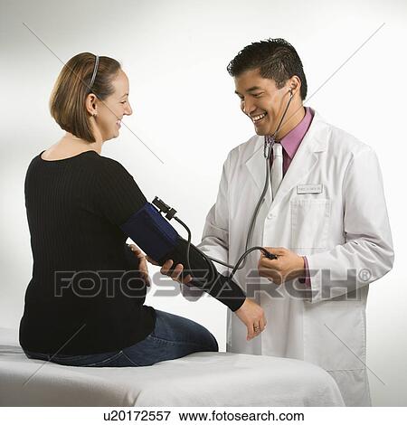 Asian American male doctor testing blood pressure of pregnant Caucasian woman. View Large Photo Image Stock Photo - Asian American male doctor testing blood pressure of pregnant Caucasian woman.. Fotosearch