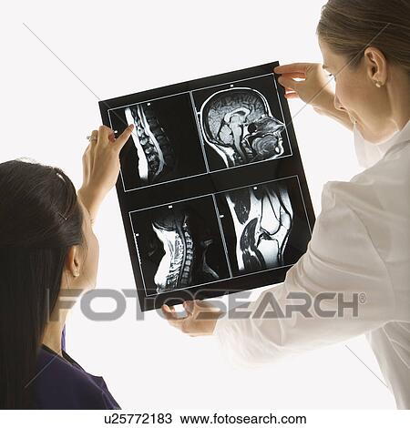 Caucasian and Asian Chinese mid-adult female doctors analyzing x-ray. View Large Photo Image Stock Image - Caucasian and Asian Chinese mid-adult female doctors analyzing x-ray. . Fotosearch
