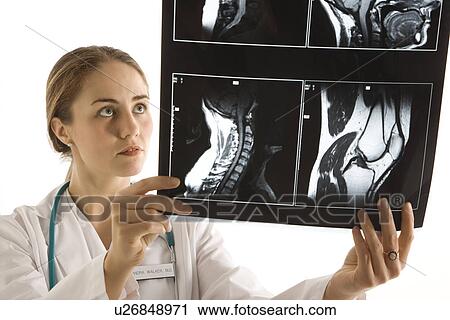 Caucasian mid-adult female doctor analyzing x-ray. View Large Photo Image Stock Image - Caucasian mid-adult female doctor analyzing x-ray. . Fotosearch