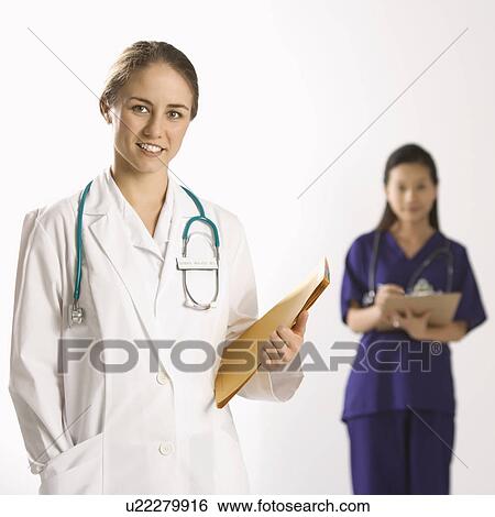 Caucasian mid-adult female doctor smiling and looking at viewer with Asian Chinese mid-adult female physician's assistant standing in background. View Large Photo Image Stock Photograph - Caucasian mid-adult female doctor smiling and looking at viewer with Asian Chinese mid-adult female physician's assistant standing in background.. Fotosearch