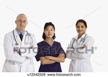 Stock Photo - Caucasian mid adult male physician with Asian and Indian women doctors.. Fotosearch