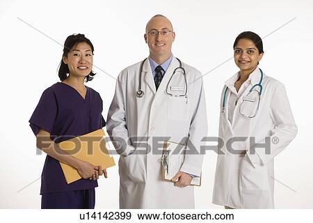 Stock Photo - Caucasian mid adult male physician with Asian and Indian women doctors.. Fotosearch