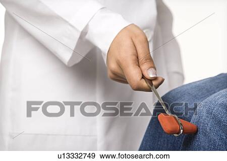 Stock Photo - Close up of woman doctor doing flex test on patient.. Fotosearch