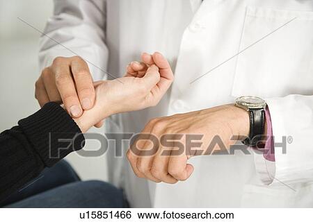 Doctor taking patient's pulse. View Large Photo Image Stock Photograph - Doctor taking patient's pulse.. Fotosearch