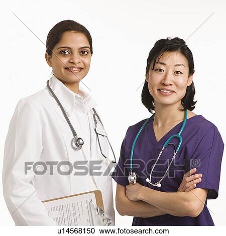Stock Image - Indian and Asian mid adult woman doctors portrait on white background.. Fotosearch