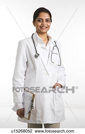 Stock Image - Indian woman doctor portrait standing against white background.. Fotosearch