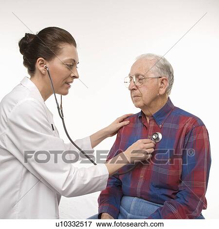 Stock Photo - Mid-adult Caucasian female doctor listening to elderly Caucasian male's heartbeat with stethoscope.. Fotosearch