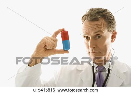 Mid-adult Caucasian male doctor holding an oversized medical pill. View Large Photo Image Stock Photograph - Mid-adult Caucasian male doctor holding an oversized medical pill.. Fotosearch