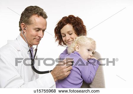 Middle-aged adult Caucasian male doctor holding stethoscope to female toddler's back with mother watching. View Large Photo Image Stock Photo - Middle-aged adult Caucasian male doctor holding stethoscope to female toddler's back with mother watching.. Fotosearch