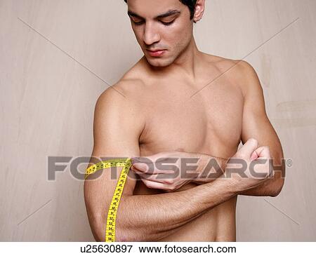 Man measuring his arm muscle View Large Photo Image Stock Photo - Man measuring his arm muscle. Fotosearch