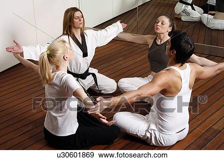 Participants in a fitness class practicing breathing exercises View Large Photo Image Stock Photo - Participants in a fitness class practicing breathing exercises. Fotosearch