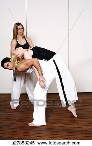 Partners practicing flexibility in yoga and Capoeira programs View Large Photo Image Stock Photography - Partners practicing flexibility in yoga and Capoeira programs. Fotosearch