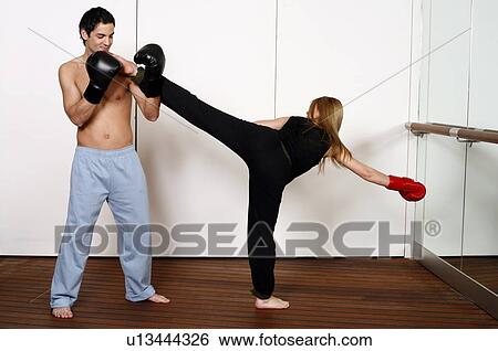 Stock Photograph - Side kick of Active Tae Bo. Fotosearch