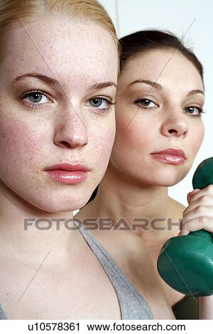 Two young women with dumbbell View Large Photo Image Stock Image - Two young women with dumbbell. Fotosearch