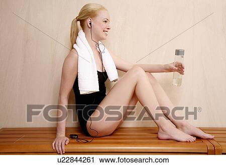 Woman relaxing in locker room after the gym View Large Photo Image Stock Image - Woman relaxing in locker room after the gym. Fotosearch