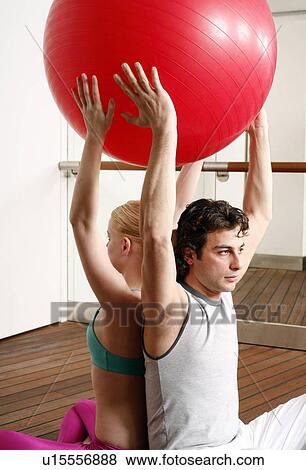 Young man and woman performing a pilates exercise View Large Photo Image Stock Photo - Young man and woman performing a pilates exercise. Fotosearch