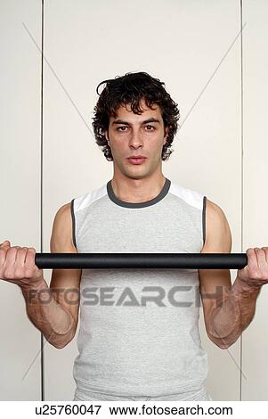 Young man lifting weights View Large Photo Image Stock Photo - Young man lifting weights. Fotosearch