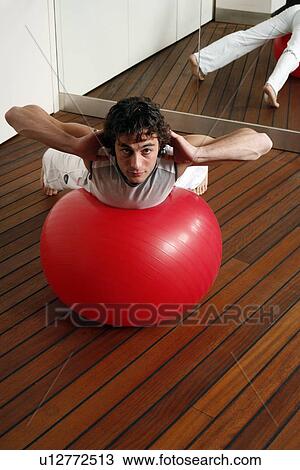 Young man performing a pilates exercise View Large Photo Image Stock Image - Young man performing a pilates exercise. Fotosearch