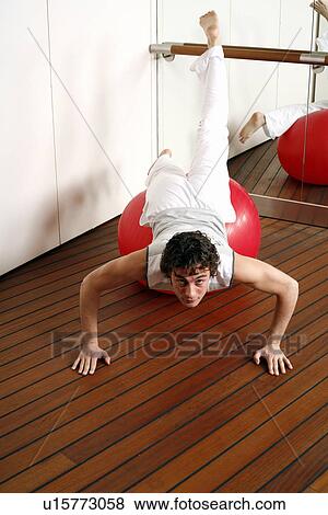 Young man performing a pilates exercise View Large Photo Image Stock Photo - Young man performing a pilates exercise. Fotosearch