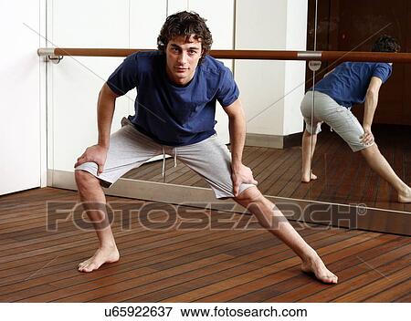 Young man stretching View Large Photo Image Stock Photo - Young man stretching. Fotosearch