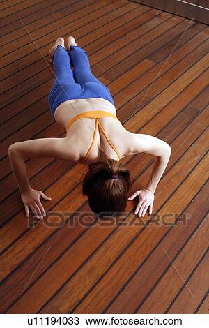 Young woman performing a pilates exercise View Large Photo Image Stock Image - Young woman performing a pilates exercise. Fotosearch