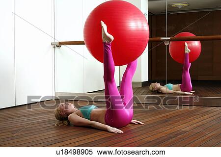 Young woman performing a pilates exercise View Large Photo Image Stock Photography - Young woman performing a pilates exercise. Fotosearch