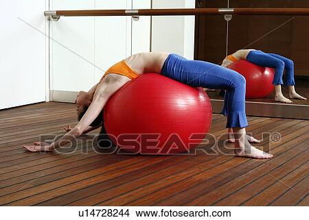 Young woman performing a pilates stretch View Large Photo Image Picture - Young woman performing a pilates stretch. Fotosearch