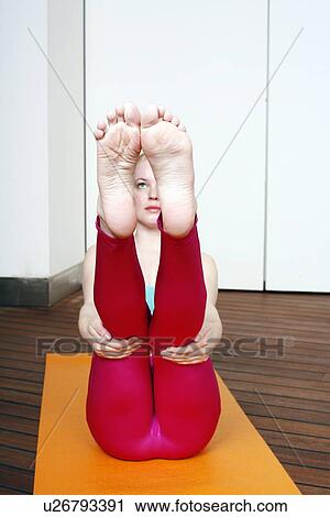 Young woman performing a pilates stretch View Large Photo Image Stock Image - Young woman performing a pilates stretch. Fotosearch