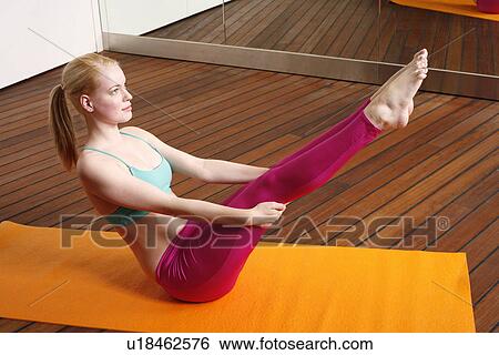 Stock Photograph - Young woman performing a pilates stretch. Fotosearch