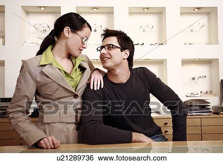 Stock Photograph - Couple posing with eyeglasses in store. Fotosearch