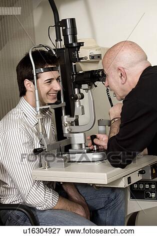 Stock Photo - Optometrist examining patient. Fotosearch