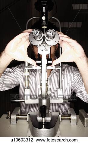 Stock Image - Patient at optometrist. Fotosearch