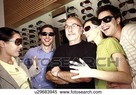 Two couples posing with sunglasses in store with shopkeeper View Large Photo Image Stock Photography - Two couples posing with sunglasses in store with shopkeeper. Fotosearch
