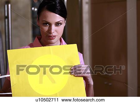 Stock Image - Woman holding optical chart. Fotosearch