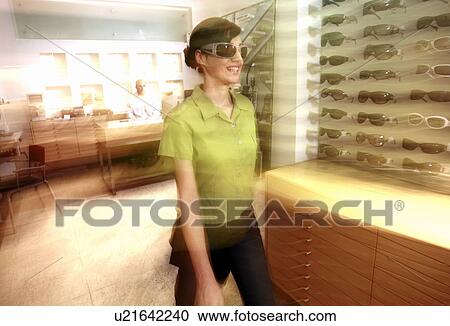 Woman shopping in sunglasses store View Large Photo Image Stock Image - Woman shopping in sunglasses store. Fotosearch