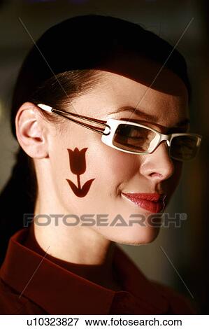 Woman wearing glasses with tulip shape on her face View Large Photo Image Stock Photo - Woman wearing glasses with tulip shape on her face. Fotosearch